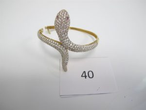 1 Bracelet en or ouvrant pavé de pierresblanches dont 2 manquantes(D6cm)à décor d'un serpent.PB24,4g.