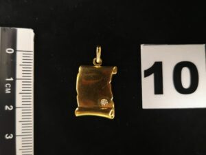 1 Pendentif parchemin en or orné d'une petite pierre. PB 1,3g