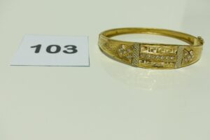 1 Bracelet en or rigide et ouvrant motif central orné de petites pierres (Diamètre 5,5/7cm). PB 9,4g