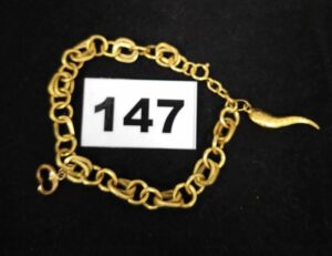 1 Bracelet grosse maille (L 18,5cm) et 1 pampille piment et bout de clef. Le tout en or 750/1000 18k. PB 8,1g