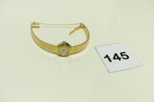 1 montre pour dame de marque HMC, bracelet et boîtier or 750/1000 avec chaînette de sécurité (HS, petit choc sur le boîter, L14cm). PB 23,6g