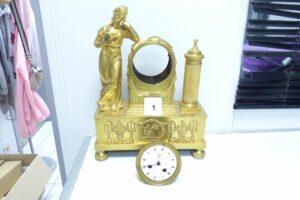 1 Pendule en bronze dorée représentant une femme lisant un livre au alégorie des sciences cadrant signé LEROY horloger du roi à Paris (accidentée) mouvement hors service balancier absent, époque restauration.