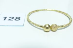 1 Bracelet rigide et ouvragé (Daimètre 7cm) en or poli et granité 750/1000. PB 20,4g