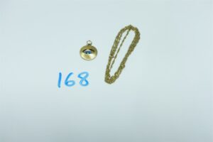 1 pendentif à décor d'un oeil avec pierre et 1 chaîne maille torsadée (L68cm). Le tout en or 750/1000. PB 5,8g