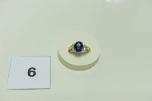 1 bague en or 750/1000 ornée d'une pierre bleue épaulée de 6 petits diamants (Td62). PB 7,4g
