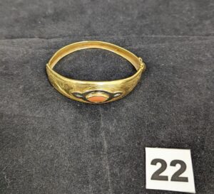 1 Bracelet rigide ouvrant orné d'un cabochon de pierre de couleur orangée en or 750/1000 18k. PB 20,5g