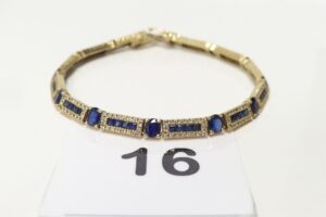 1 Bracelet chenille en or 585/1000 14k, orné de nombreuses pierres bleues et petits diamants (manque 1 pierre et 1 diamant)(L19cm). PB 17,4g