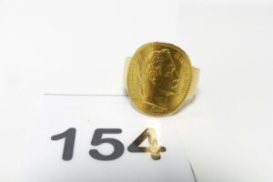 1 Bague en or 750/1000 sertie d'une pièce de 20frs en or 900/1000 NAPIII (td66). PB 12,2g
