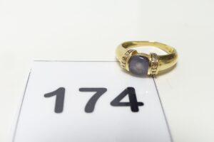 1 Bague en or 750/1000 ornée d'une pierre violette usée épaulée de petits diamants (td56). PB 3,6g